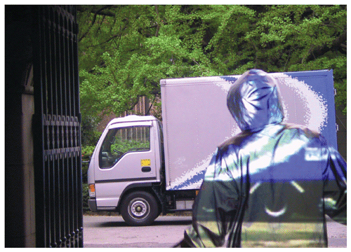Another approach to optical invisibility is to record the background scene and then project it onto an obstructing object, in this case the retroreflective garment worn by the person above. The illusion works only from a limited set of viewing angles. This method is not strictly cloaking, as the light waves are not guided around an object, but it has some similar potential protective uses, such as allowing drivers to see through blind spots in their vehicles. <strong>Photograph courtesy of Tachi Laboratory, University of Tokyo.</strong>
