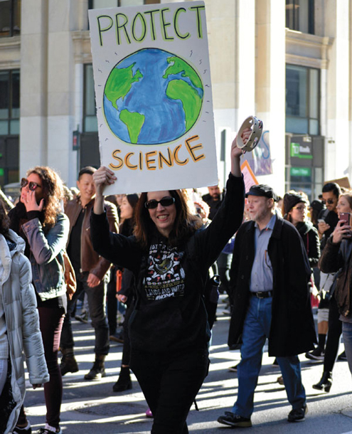 A protester at a rally opposing the election of Donald Trump as president of the United States holds a sign that responds to the antiscience rhetoric brought out during the campaign. <strong>Christopher Penler/Alamy Stock Photo</strong>